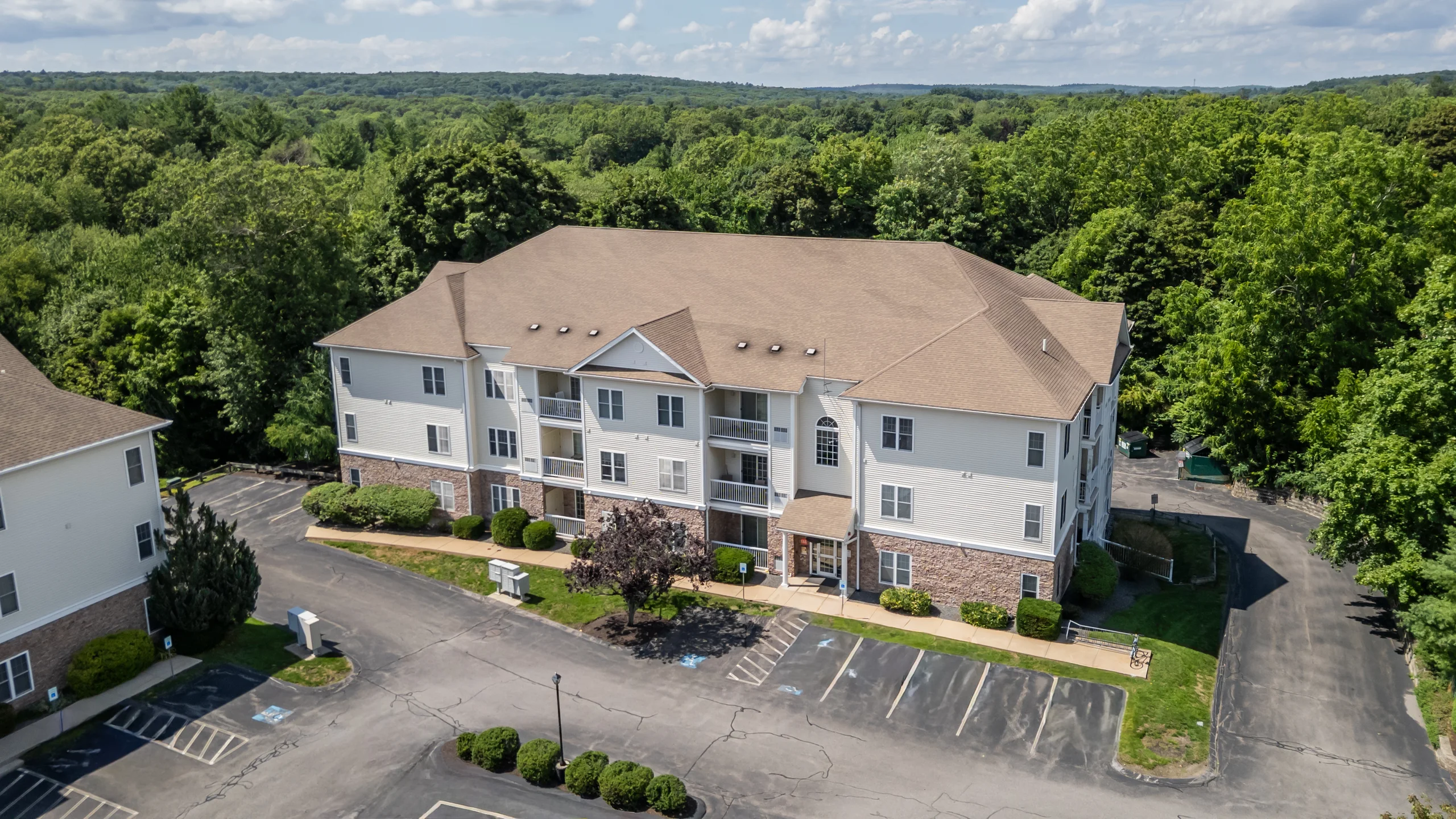 Aerial view of Chestnut Park Apartments on its wooded grounds in North Attleboro, Massachusetts.